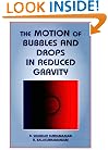 The Motion of Bubbles and Drops in Reduced Gravity