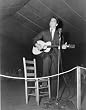 1940s photo Alan Lomax playing guitar on stage at the Mountain Music Festival, Asheville, N.C. .