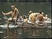 Nude Young Man Sitting on Dock, Enjoying Skinny Dipping in River at Woodstock Music and Art Festival Photographic Poster Print by Bill Eppridge, 16x12