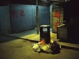 IMAGE OF Pile of Garbage Next to a Trash Can on a Hong Kong Street at Night Premium Photographic Poster Print by Eightfish , 24x32