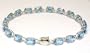 Oval Blue Topaz Line Bracelet - JewelryWeb