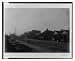 Historic Print (L): [Exterior view of houses along unpaved street in Georgia]
