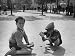 Child Scavengers Dividing Their Morning's Accumulation of Cigarette Butts Photographi...