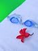 Close-up of a Frangipani Flower and a Swimming Goggle on a Towel - 18