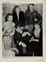 HEROES IN HOLLYWOOD: "Sighted sub, sank same" is famous report of Ensign Donald Mason, demonstrating how he dived his plane and dropped two bombs on a submarine in the Atlantic. Clustered around him counterclockwise: CLAUDETTE COLBERT, CAROLE LANDIS, BETTY GRABLE, RUTH HUSSEY and GEORGE WELCH, Medal of Honor Nominee who brought down four Jap planes at Pearl Harbor. ..... 1942 LIFE Magazine Picture, A4457A.