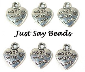 25 x Silver Tone 'Made With Love' Heart Charms (12mm) with Jump Rings included for attachments. Universal use for Jewellery, Card Making and Scrap-booking. Check out our Fantastic wide range of Beads, Charms and Findings (Ref:10A36)