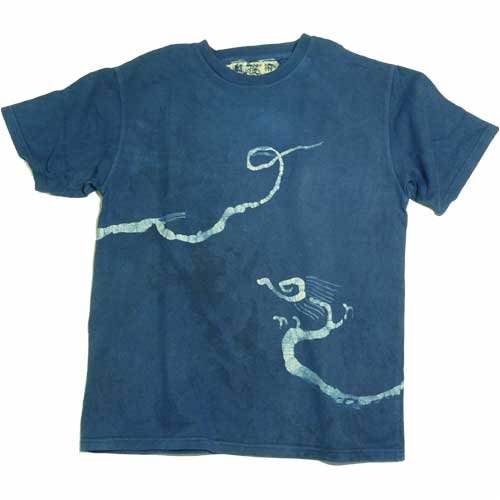 Batik Dragon T-Shirt made in Thailand. Each is a handmade unique work of art. Candle wax is applied to a white shirt to create the dragon design. Natural dyes are used to achieve an earthy brown, an indigo blue and an indigo black.