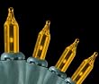 Set of 140 Amber Everglow Chasing Mini Christmas Lights - Green Wire