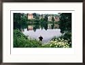 Man Fishing in Lake in In Oliwa, Gdansk, Poland Places Framed Photographic Poster Print by Rick Gerharter, 29x21