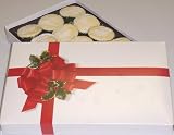 Scott's Cakes 1 lb. White Chocolate Coconut Cluster in a Ribbon n Holly Box