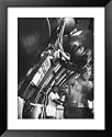 Boxer Rocky Marciano, Working Out Punching Bag, at Training Camp, Before Fight with Archie Moore Framed Art Poster Print by Grey Villet, 27x33