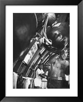 Boxer Rocky Marciano, Working Out Punching Bag, at Training Camp, Before Fight with Archie Moore Framed Art Poster Print by Grey Villet, 27x33