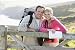 Wallmonkeys Peel and Stick Wall Decals - Couple on Cliffside Outdoors Leaning on Railing and Smiling - Removable Graphic