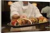 Box Canvas Print of Sushi chef presents a plate of various seafood sushi from Robert Harding