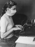 Typist in Office Wearing Surgical Mask as a Prophylactic Measure During Influenza Outbreak Photographic Poster Print, 12x16