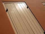 Close-up of an Adobe House with White Window Shutters Photographic Poster Print, 18x24
