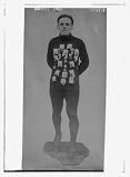 Photo (L): Harry Cody with sports medals Image