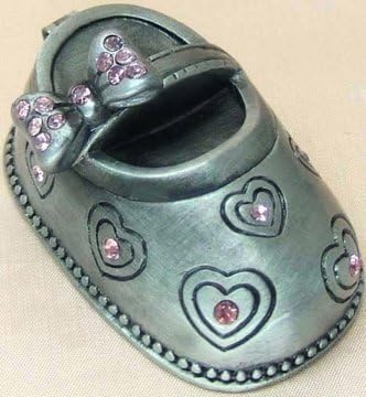 Baby Girl Pewter Shoe Trinket Box. Adorable Pewter Trinket Box in Shape of a Baby Shoe, Adorned with Pink Stones. Designed with Little Hearts and Bow on the Shoe Top. Packaged in a Pink Base and Clear Cover with Pink Ribbon. Great for Storing Her Little Curl or Little Tooth. Measure Around 2"long, 1" Wide.