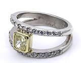 Diamond RIng center stone is an EGL Certified 1.09ct Natural Fancy Intense Yellow Radiant Cut Diamond set with 26 round diamonds down the split shank 0 .40ct tw.