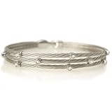 18 Karat White Gold Three-Strand Wire Bracelet, Enhanced with Bezel Set Diamonds.
