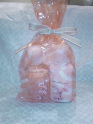 Bath & Body Works Cherry Blossom gift bag 4oz bottle of shower gel and body lotion. Includes mesh shower sponge.