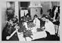 Buyenlarge 02576-xCG28 Family Sitting at Table Working with Garters 28x42 Giclee on Canvas