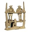 Two mudmen on water wheel - ceramic 3.5"H