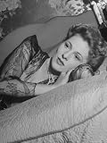 Actress Joan Fontaine Wearing Sheer Negligee While Lounging on Bed at Home Premium Photographic Poster Print by Bob Landry, 24x32