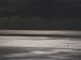 A Lone Boat Sails on a Silvery Sea Photographic Poster Print by Jodi Cobb, 18x24