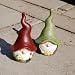 A Pair Of Terracotta Gnome Garden Ornaments Red & Green Hats