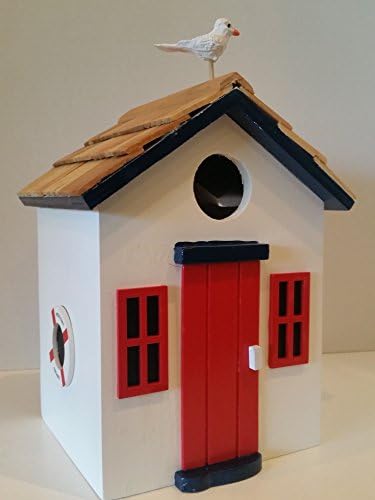 Beach Cottage Birdhouse is a Wood Birdhouse in Pure White with a Pine Wood Shingled Roof, Red Accents, Blue Trim and a Bright Red Front Door with a Seagull on the Roof of this Charming Wood Birdhouse