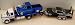 Jada Toys 1/24 Scale Diecast Flatbed Tow Truck International Durastar 4400 in Color White with Blue Flatbed with Black Diecast Trailer with Two Car Combo 1/24 Scale Big Time Muscle Diecast 1955 Chevy Stepside Pickup with Blown Engine in Color Blue and Dub City 1/24 Scale Diecast 1960 Chevy Impala in Color Black