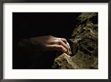 A close view of a climbers hand utilizing a natural hold Framed Art Poster Print by Bobby Model, 29x21