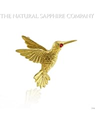 18K gold bird brooch with ruby eye.