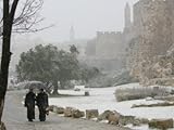 IMAGE OF Two Priests Walk in Snow in Front of the Jaffa Gate in Jerusalem's Old City, December 27, 2006 Premium Photographic Poster Print by Oded Balilty, 48x64