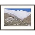 A Tibetan temple is built atop a hill with the Himalaya Mountains as a backdrop Framed Art Poster Print by Monika Klum, 29x21