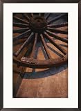 Close-up of wooden wagon wheel lit by setting sun Photography Framed Art Poster Print by Todd Gipstein, 21x29