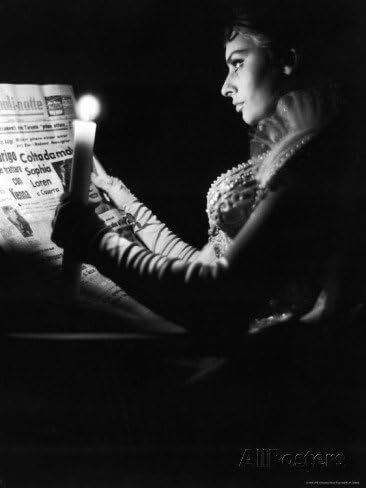 Actress Sophia Loren Reading Newspaper by Candlelight While in Costume for Madame Sans Gene Premium Photographic Poster 20*30