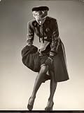41Jf2dUrGQL. SL160  Model Wearing Black Stockings, Fitted Dress Coat, Fur Trimmed Hat and Fur Muff Adjusting Garter Photographic Poster Print by Gjon Mili, 18x24