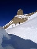 Skiers Bypass a Crevasse in a Polar Glacier Below the Troll's Castle Photographic Poster Print by Gordon Wiltsie, 30x40