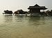Malaysian-Style Luxury Resort Villas on Stilts Hover Above the Ocean Photographic Poster Print, 24x18