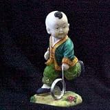 Buddah Boy Playing Push Wheel