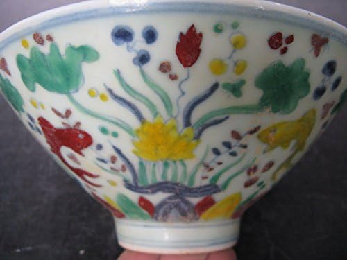 Fish Moving and Eating in Porcelain Bowl