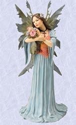 medieval fairy with gothic cross and flowers sculpture statue