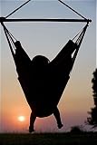 Photographic Prints of Malawi, Lake Malawi National Park. Young guest relaxes in a hammock at Pumulani from AWL Discover Images