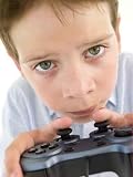 Young Boy Using Videogame Controller and Concentrating - 24