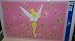 Disney's Plastic Table Placemat in Color Pink with Great Picture of Tinkerbell Standing up and Looking Behind Her Measures About 17