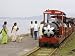 People Walk Next to Miniature Train Near Elephanta Island Art Photographic Poster Print by Mick Elmore, 16x12