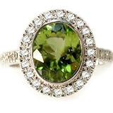 18K White Gold Ring, Bezel Set with an Oval-Shape Peridot Color-Stone and Surrounded by Pave Set Diamonds.