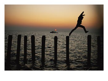 Bo Hoppin Leaps Between Pilings in the Chesapeake Bay off Great Fox Island, Virginia Photographic Poster Print by Robert Madden, 24x18